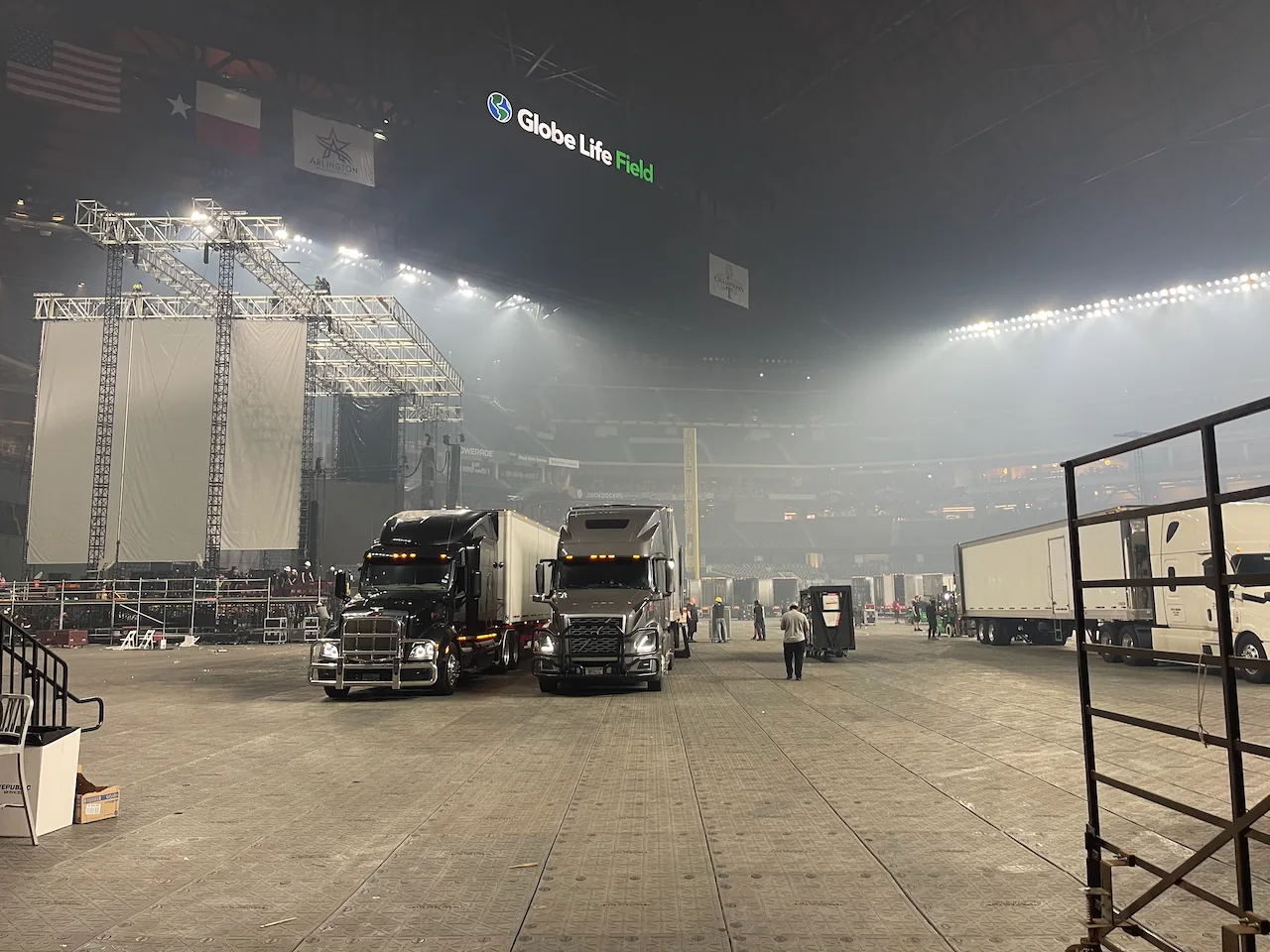 Running Turtle trucks staged beside a concert production inside an arena