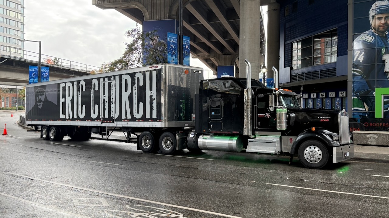 Running Turtle tractor and Eric Church tour trailer at an arena loading area