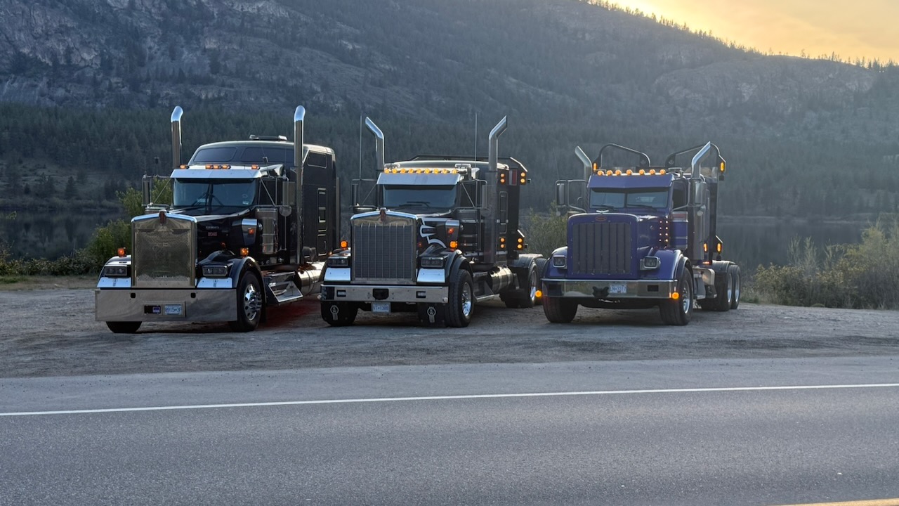 Three Running Turtle tractors staged in a mountain setting at dusk